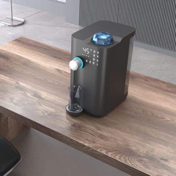 Filtered water purifier with digital display and temperature control on a wooden desk in modern kitchen.