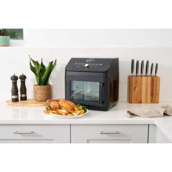 Automatic air fryer oven in modern kitchen for healthy cooking and food preparation.