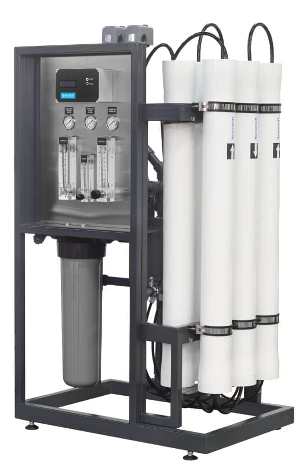 Filtration system with three vertical filters and control gauges, used for water purification and filtration purposes.